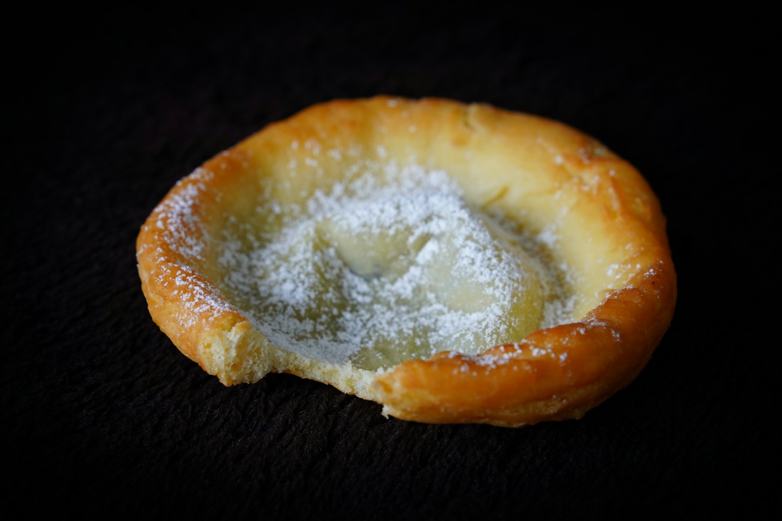 Photo by - Landsmann - A pastry with powdered sugar on top of it